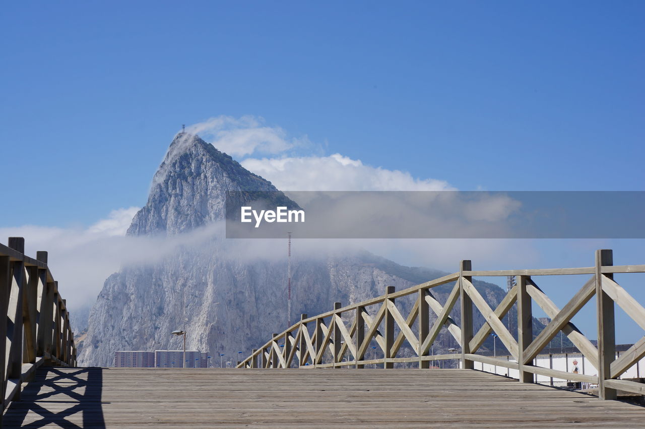 Bridge over sea against blue sky