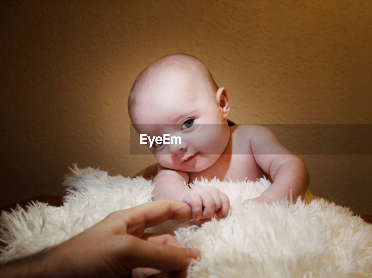 Portrait of cute baby boy against wall at home