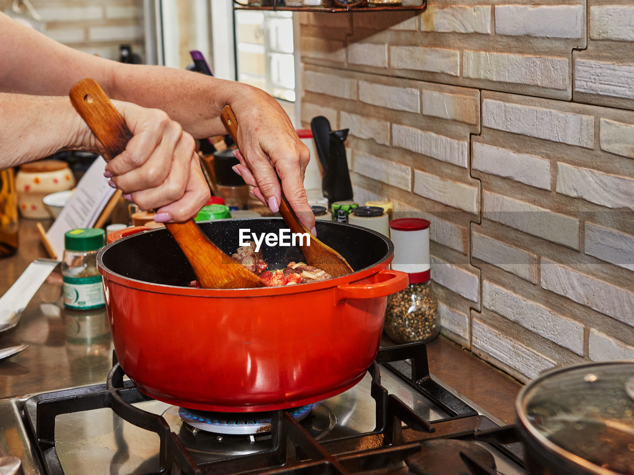 cropped hand of person preparing food on table