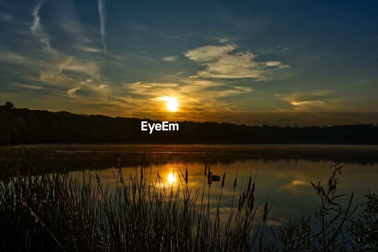 SCENIC VIEW OF SUNSET OVER LAKE