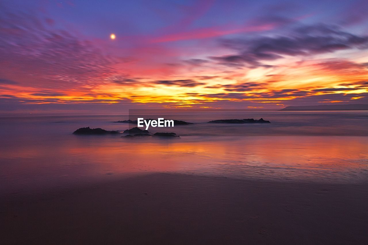 Scenic view of sea against sky at sunset