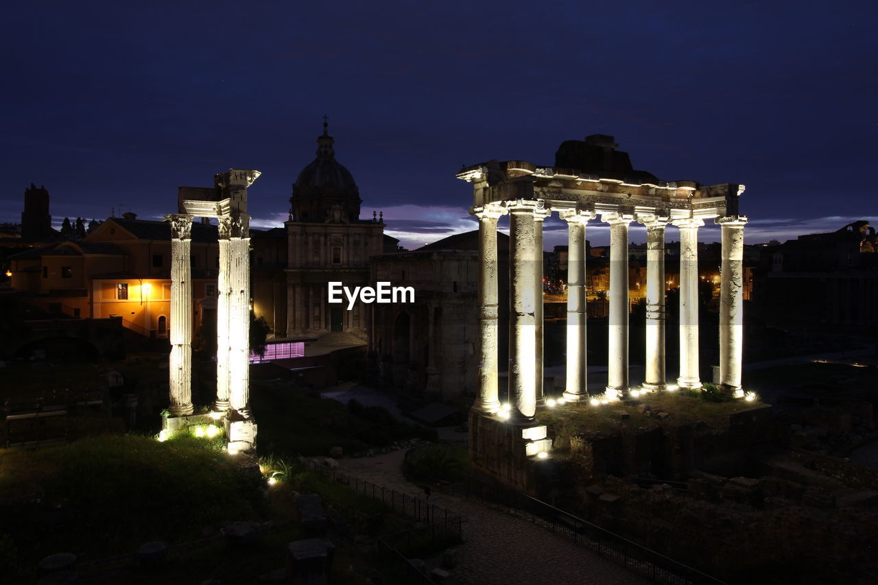 ILLUMINATED BUILDINGS AGAINST SKY AT DUSK