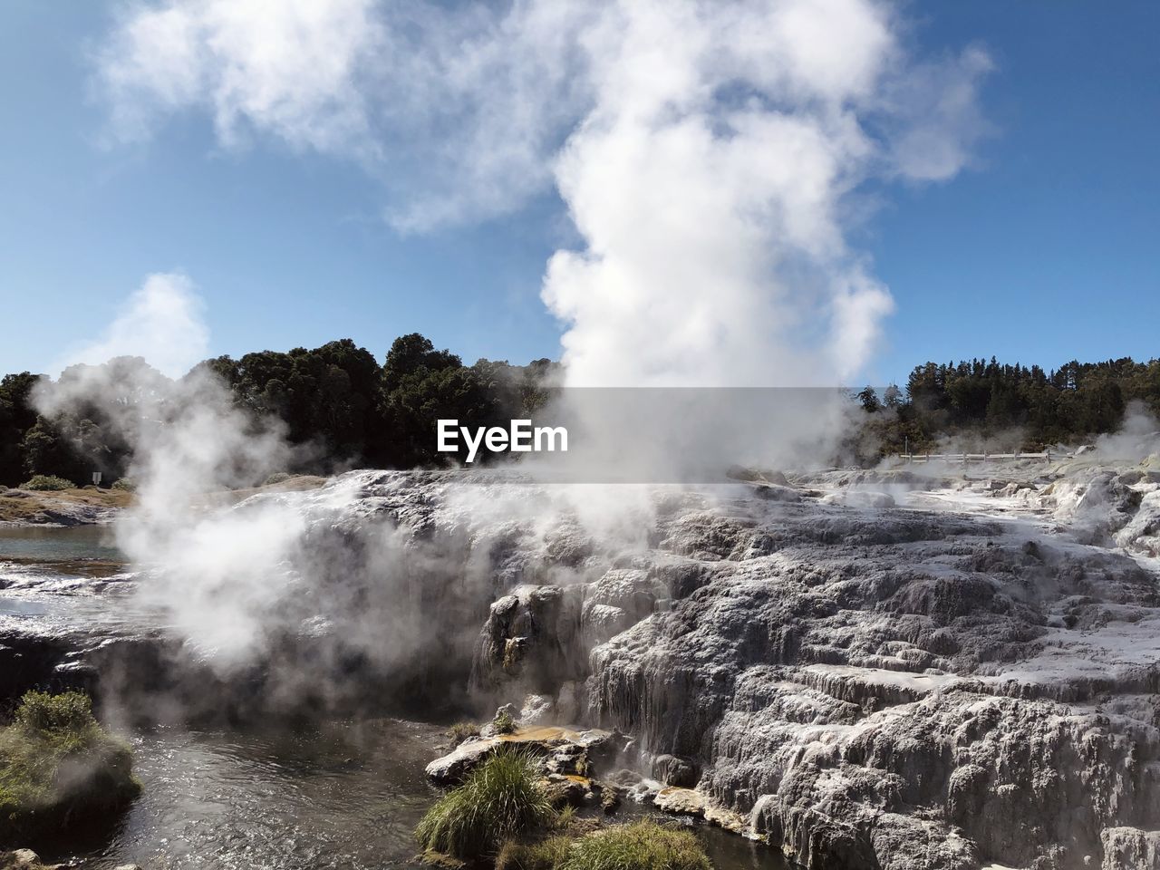 Scenic view of hot spring against sky