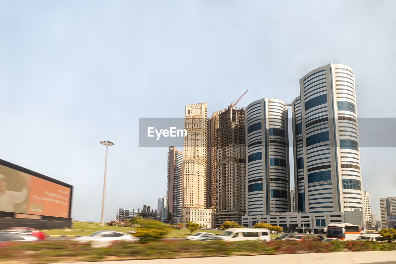 architecture, building exterior, built structure, city, building, tower block, office building exterior, sky, skyscraper, urban area, metropolitan area, cityscape, downtown, street, residential district, residential area, office, skyline, nature, landscape, urban skyline, transportation, road, landmark, business, no people, metropolis, city life, neighbourhood, car, motor vehicle, downtown district, outdoors, travel destinations, city street, day, business finance and industry, development, condominium, mode of transportation, travel, industry, copy space, construction industry, tower, facade, home ownership