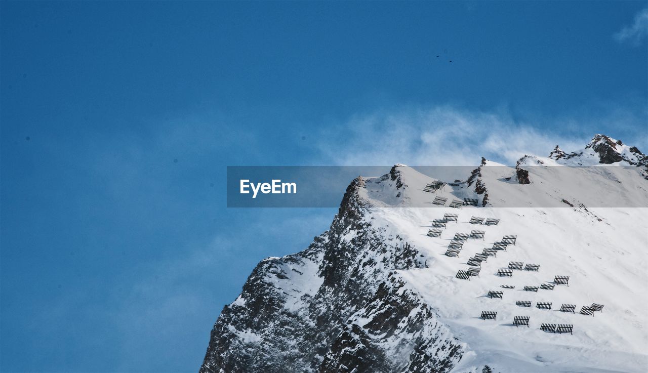 Low angle view of snowcapped mountain against sky