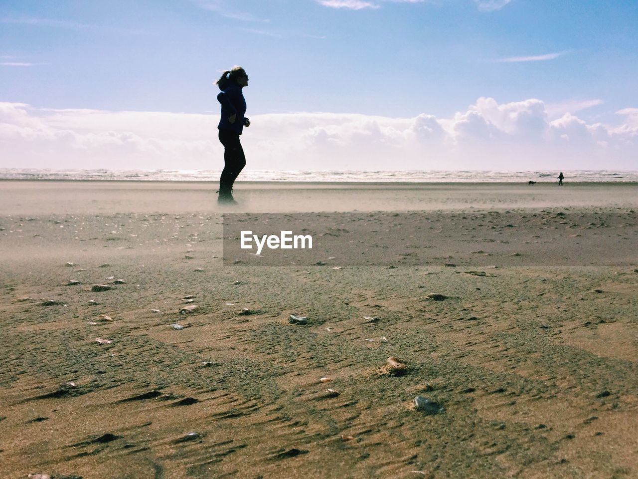 Side view of silhouette woman standing on beach