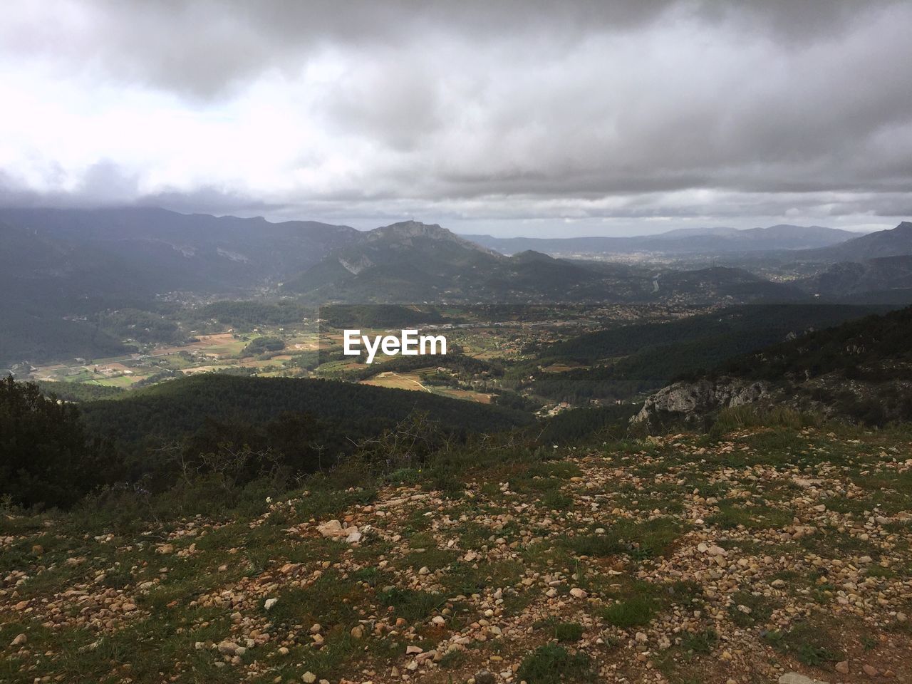 SCENIC VIEW OF MOUNTAINS AGAINST CLOUDY SKY