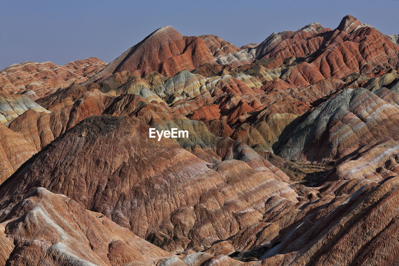 Rock formation on landscape against sky. zhangye danxia-red cloud nnal.geological park, gansu, china