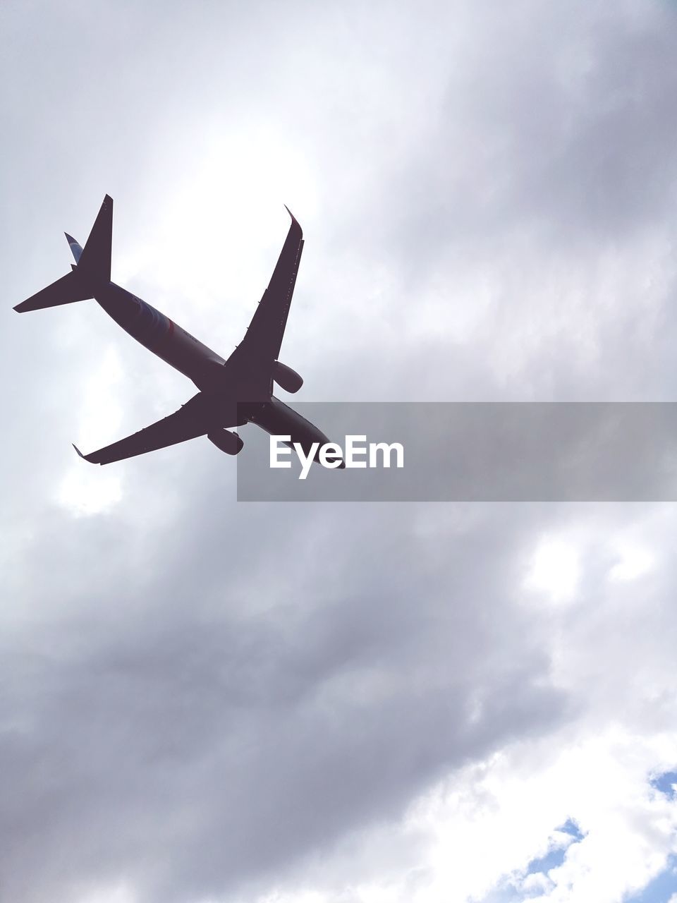 LOW ANGLE VIEW OF AIRPLANE IN SKY