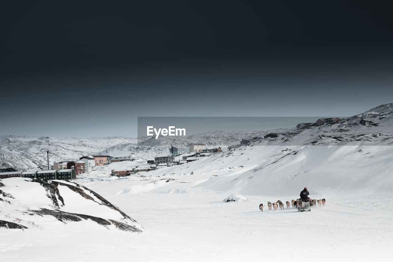 Scenic view of snow covered mountains against sky