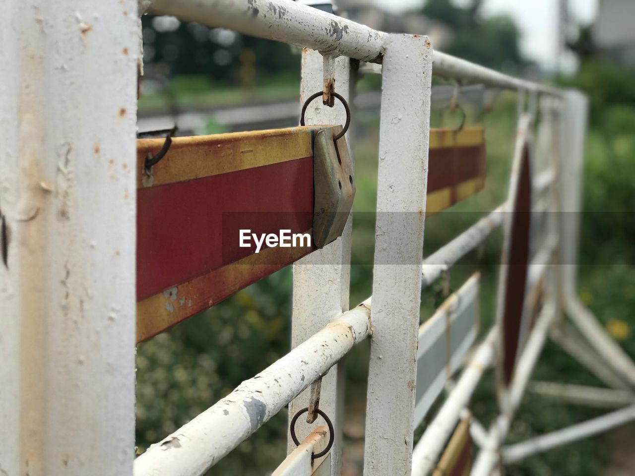 CLOSE-UP OF PADLOCK ON FENCE AGAINST METAL GATE