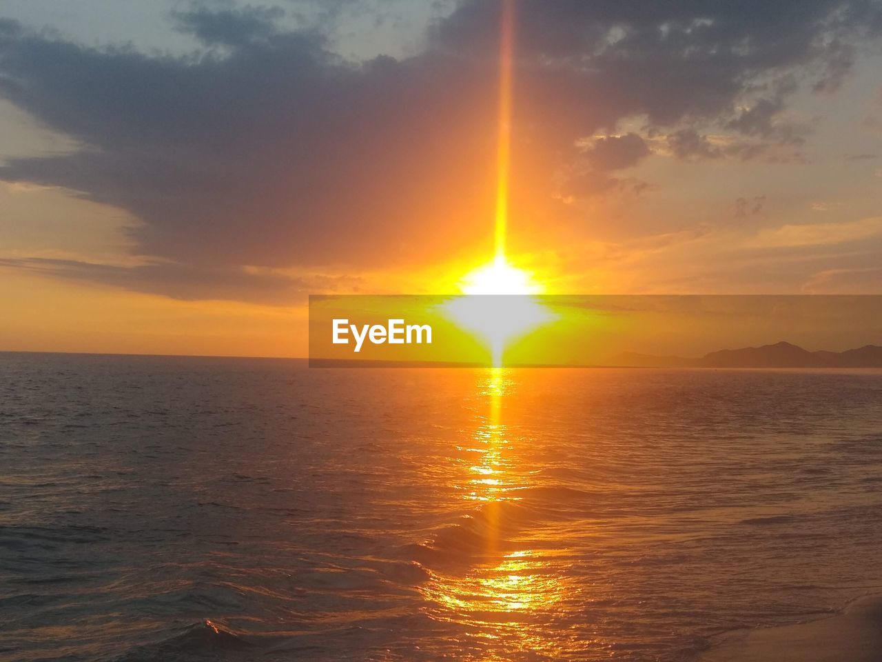 SCENIC VIEW OF SEA AGAINST ORANGE SKY DURING SUNSET