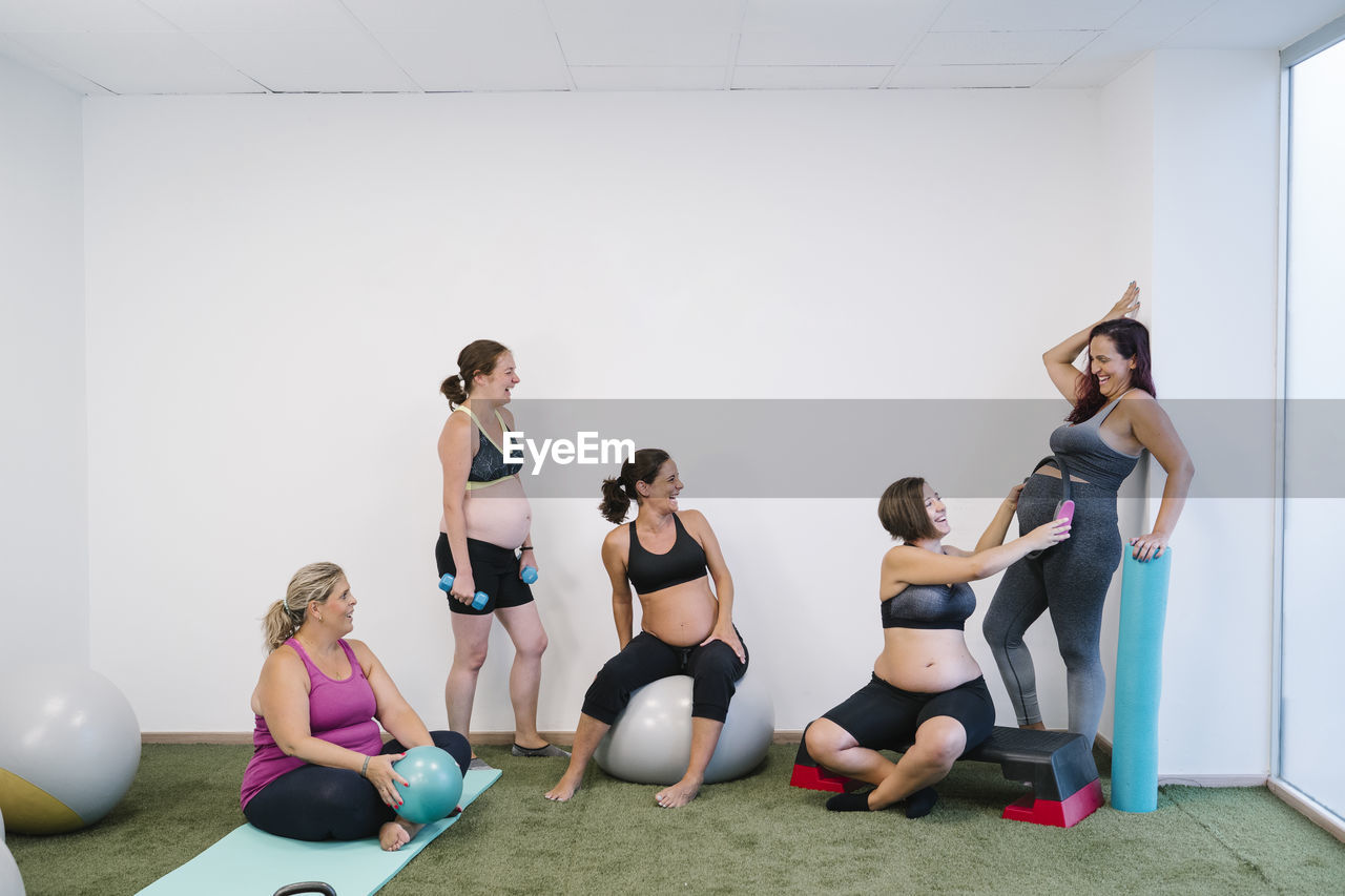 Group of pregnant woman doing exercise at yoga studio