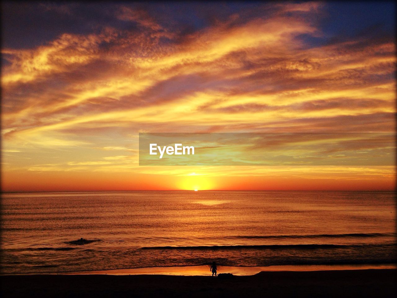 Scenic view of sea against orange cloudy sky