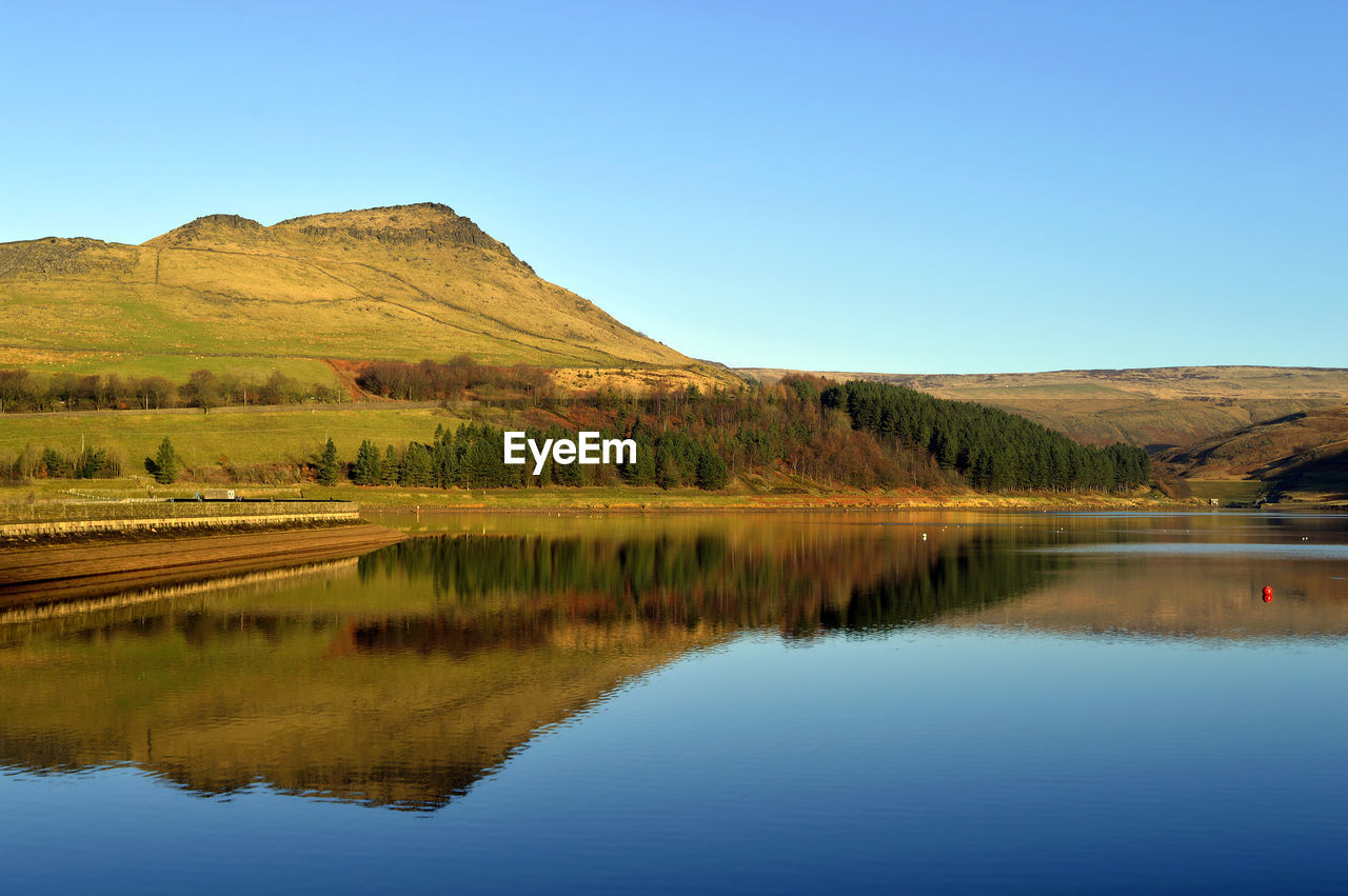 Dovestone reservoir above the village of greenfield