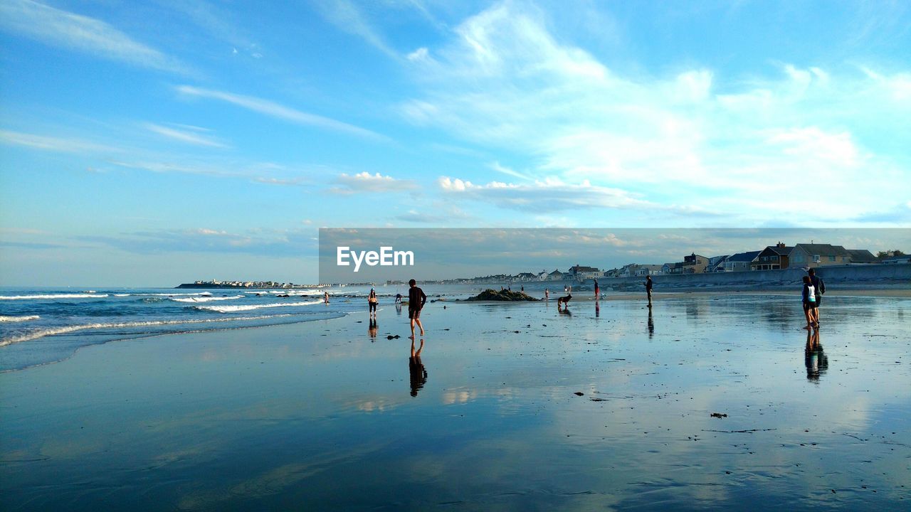 MAN AT BEACH AGAINST SKY