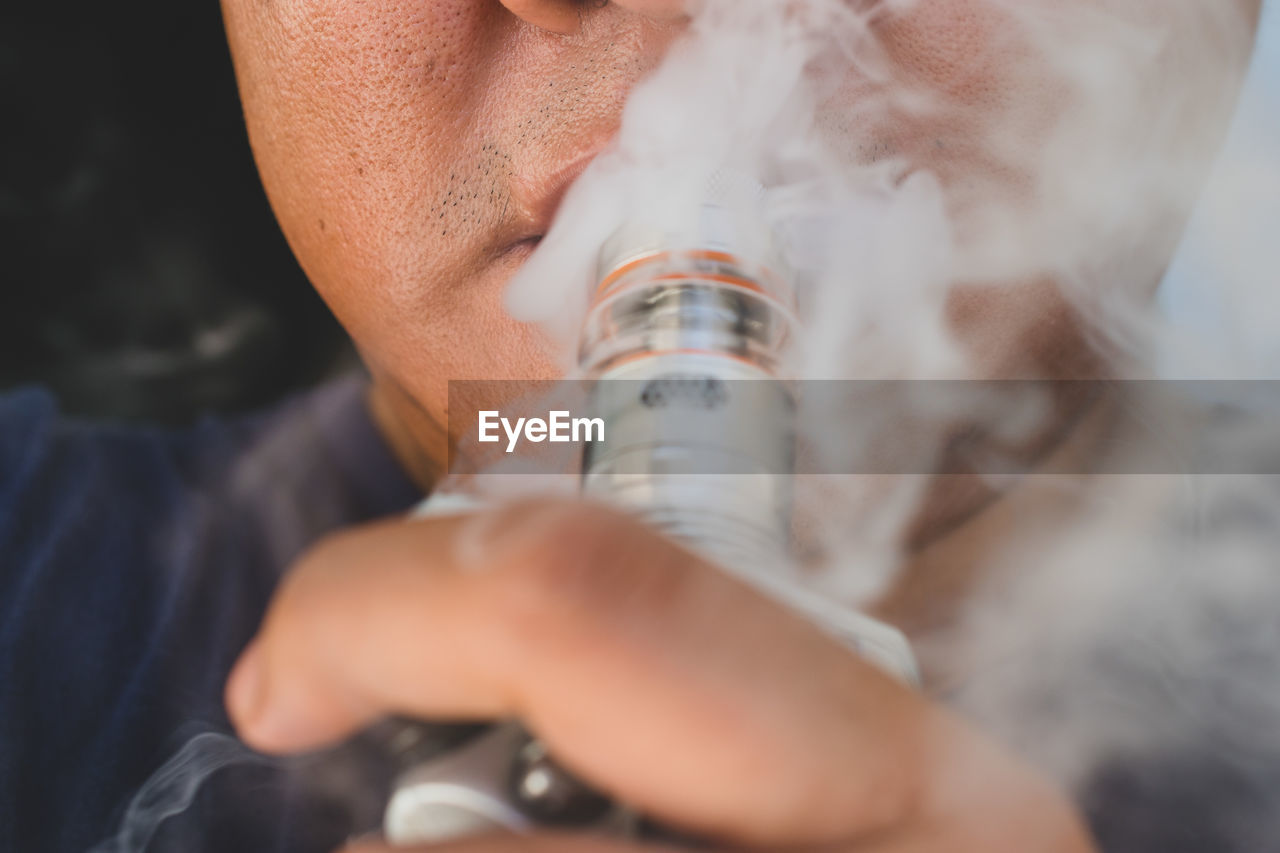 Close-up of man smoking hookah