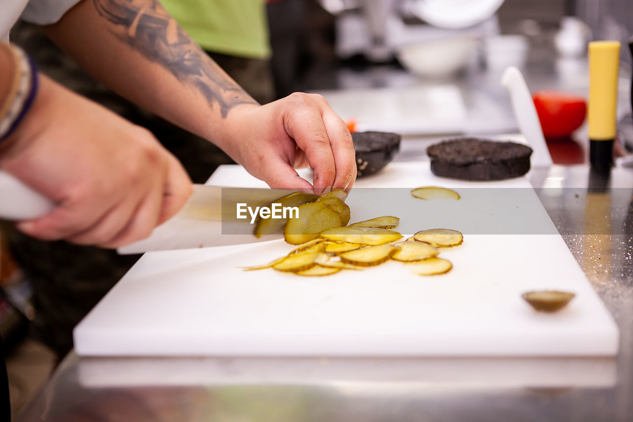 cropped hand of man preparing food