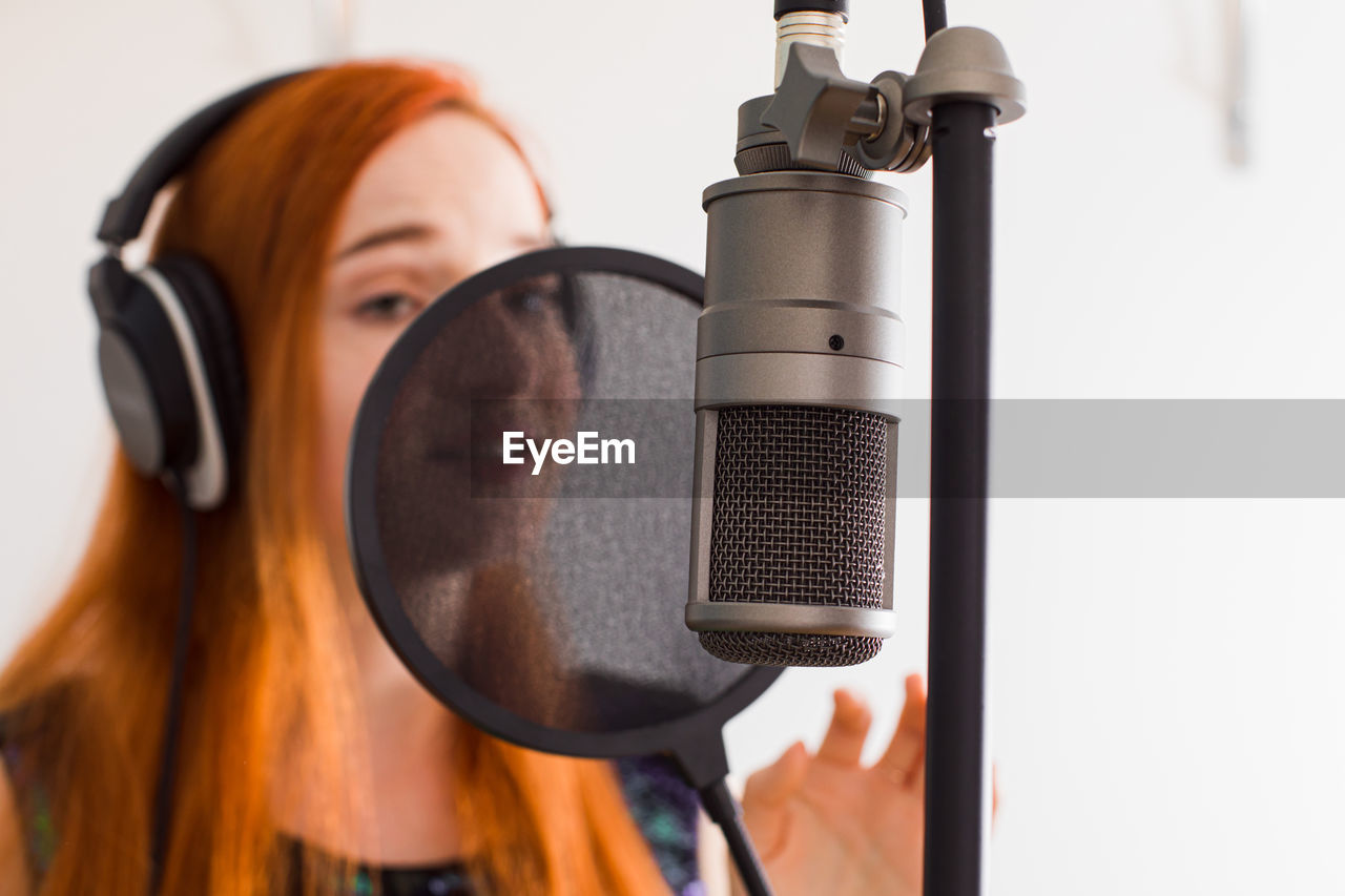 Close-up of singer singing song at studio