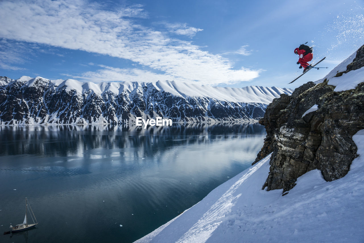 Man on skis jumps off cliff in jan mayen