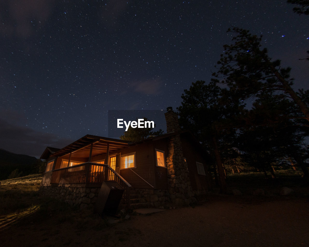 HOUSES AGAINST SKY AT NIGHT