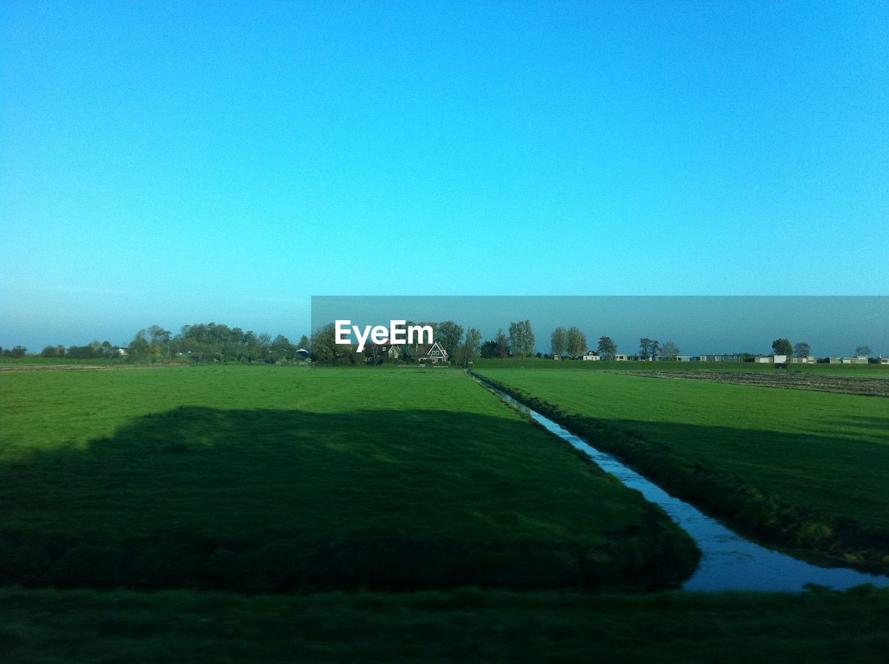 SCENIC VIEW OF GRASSY FIELD AGAINST SKY