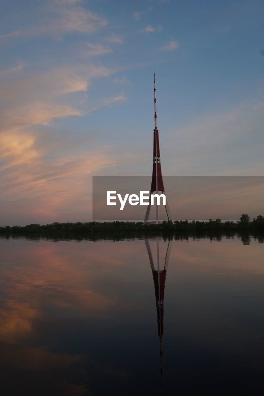 SILHOUETTE BUILT STRUCTURE BY LAKE AGAINST SKY DURING SUNSET