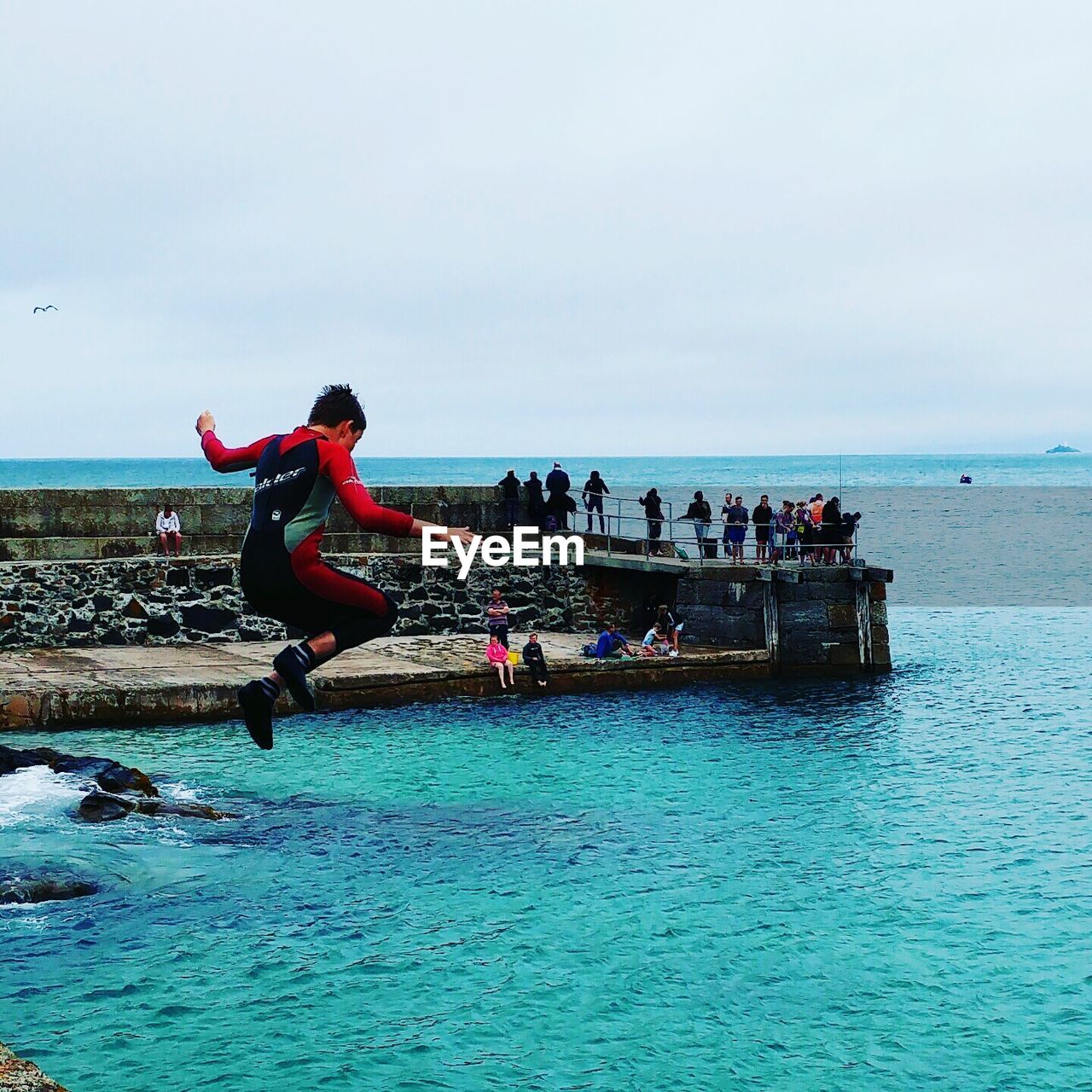 PEOPLE AT SEA AGAINST SKY