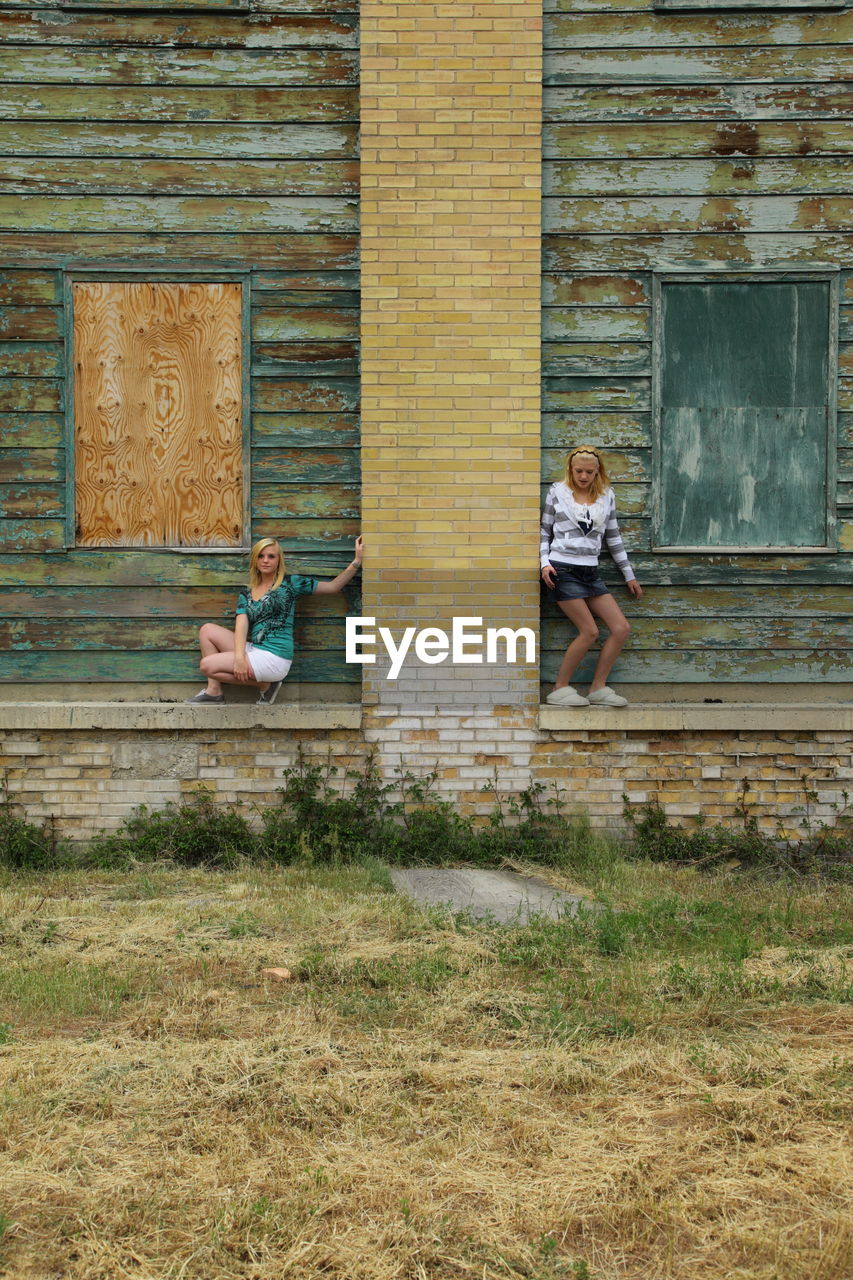 Girls against abandoned building