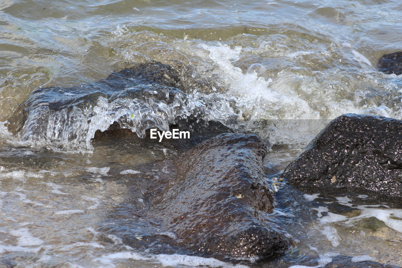 WAVES SPLASHING ON ROCKS