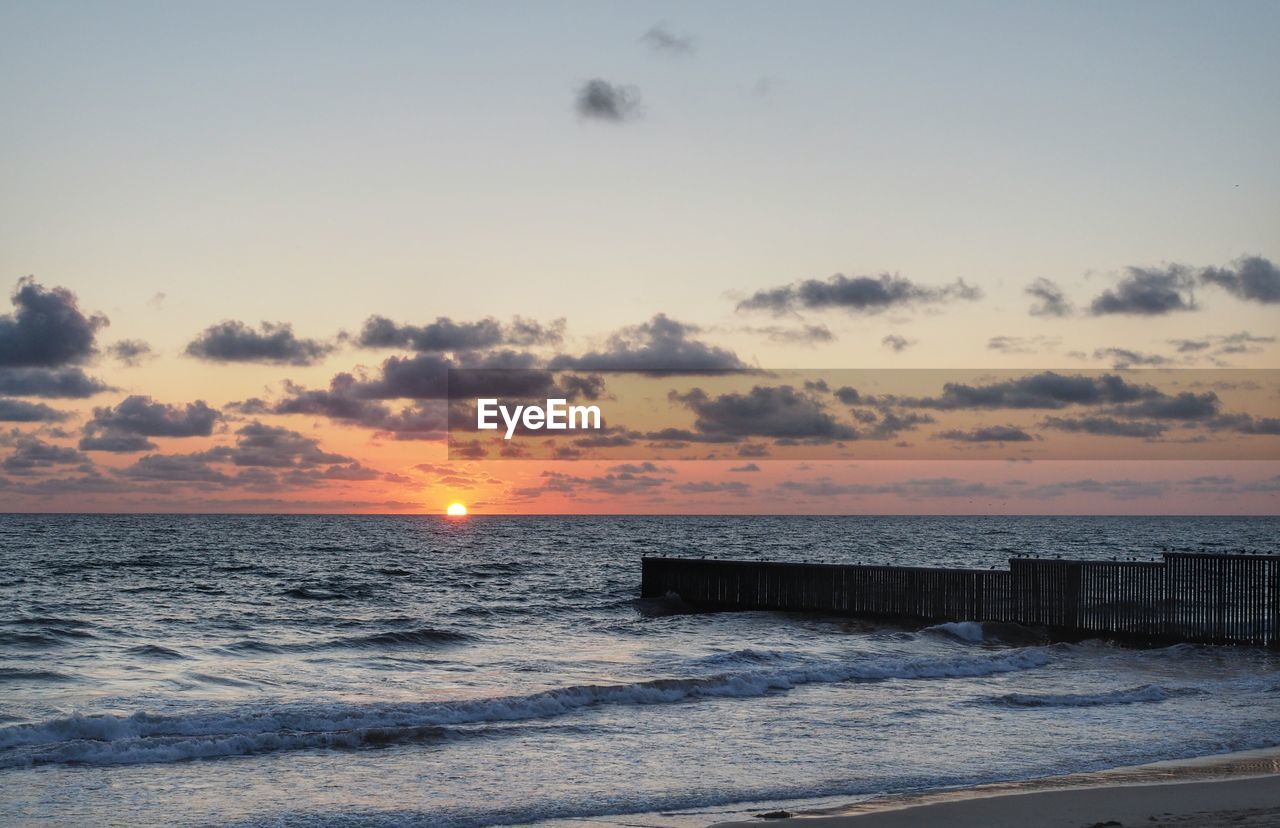 Scenic view of sea at sunset