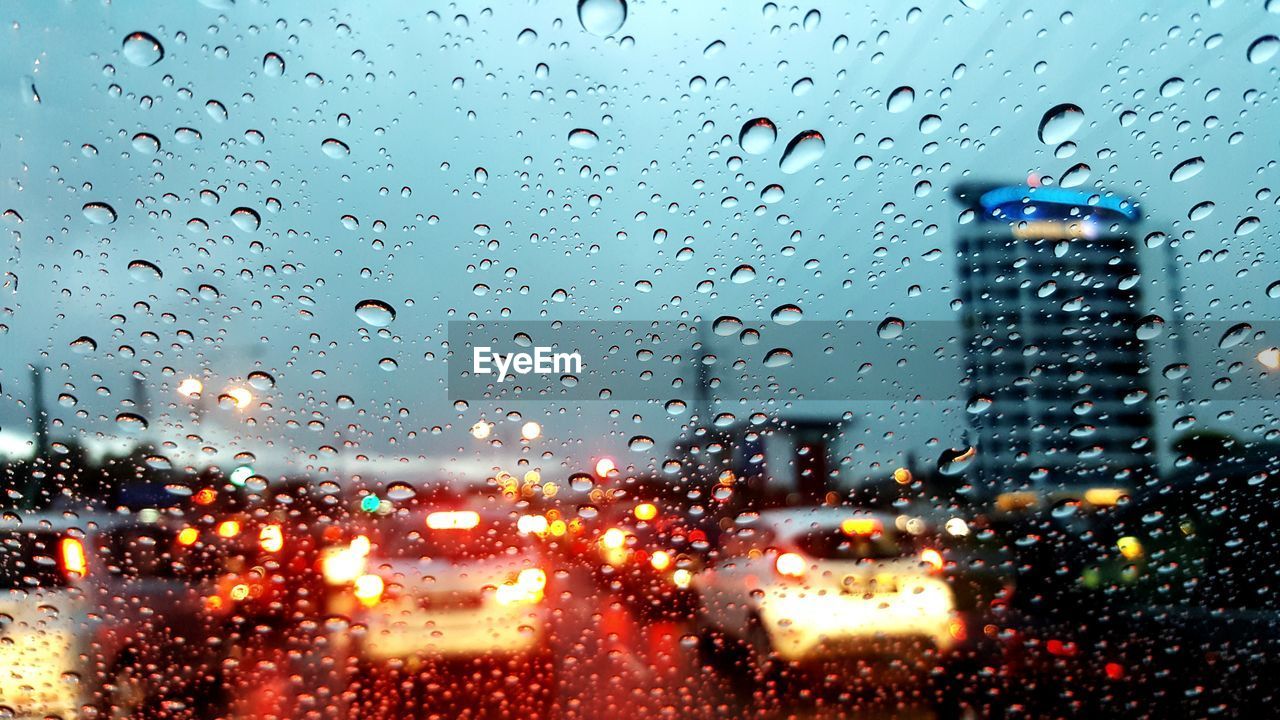 VIEW OF CITY THROUGH WET WINDOW