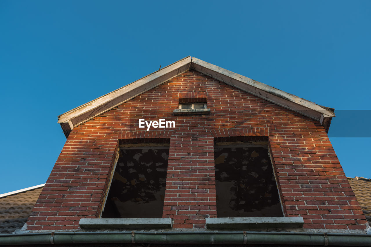 Low angle view of building against clear blue sky