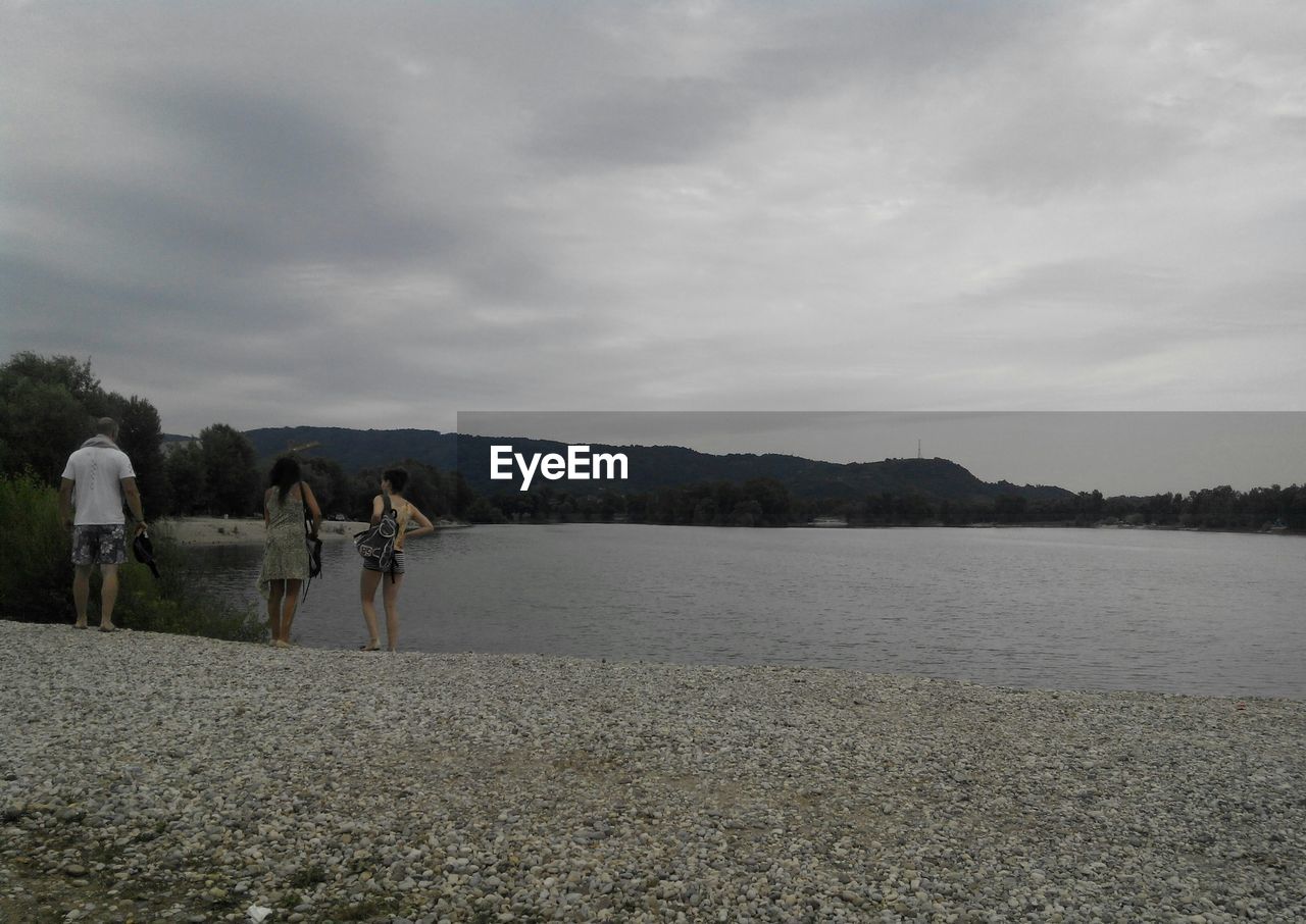 PEOPLE AT LAKE AGAINST SKY