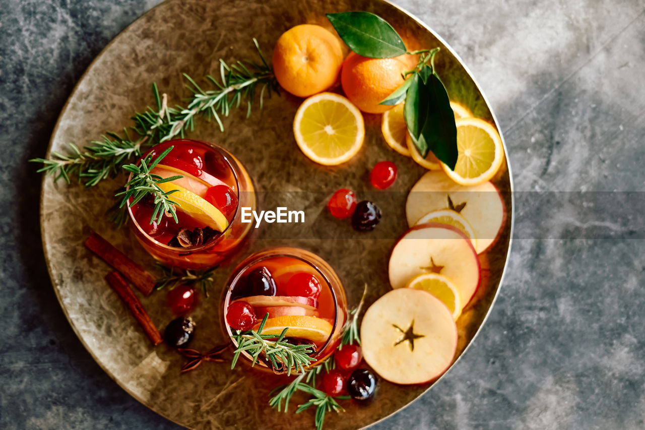 Mulled wine or christmas sangria with aromatic spices, apple, cherry and citrus fruits.