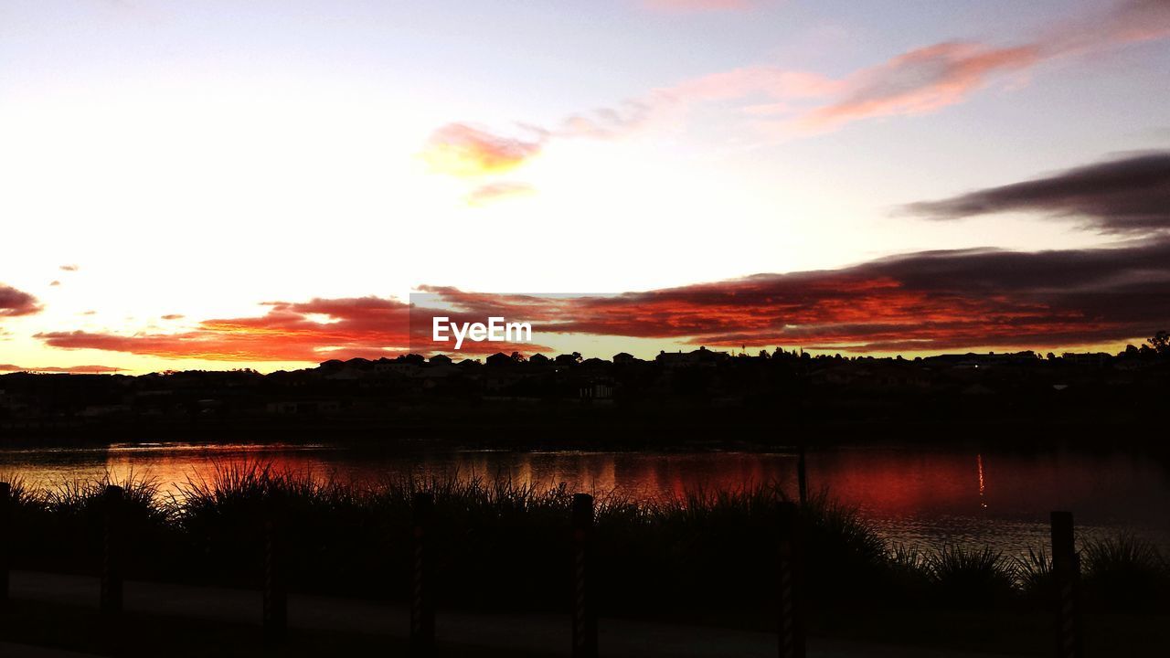 SCENIC VIEW OF LAKE AGAINST CLOUDY SKY