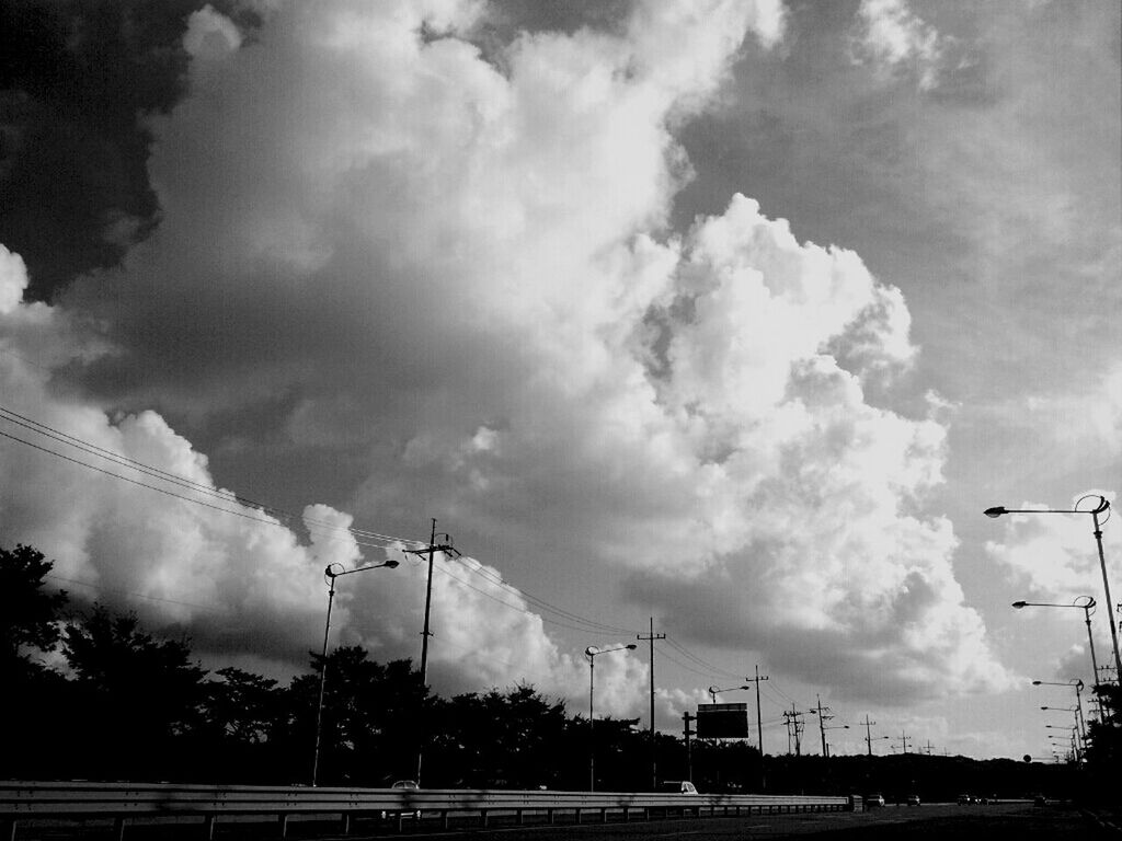 VIEW OF ROAD AGAINST CLOUDY SKY