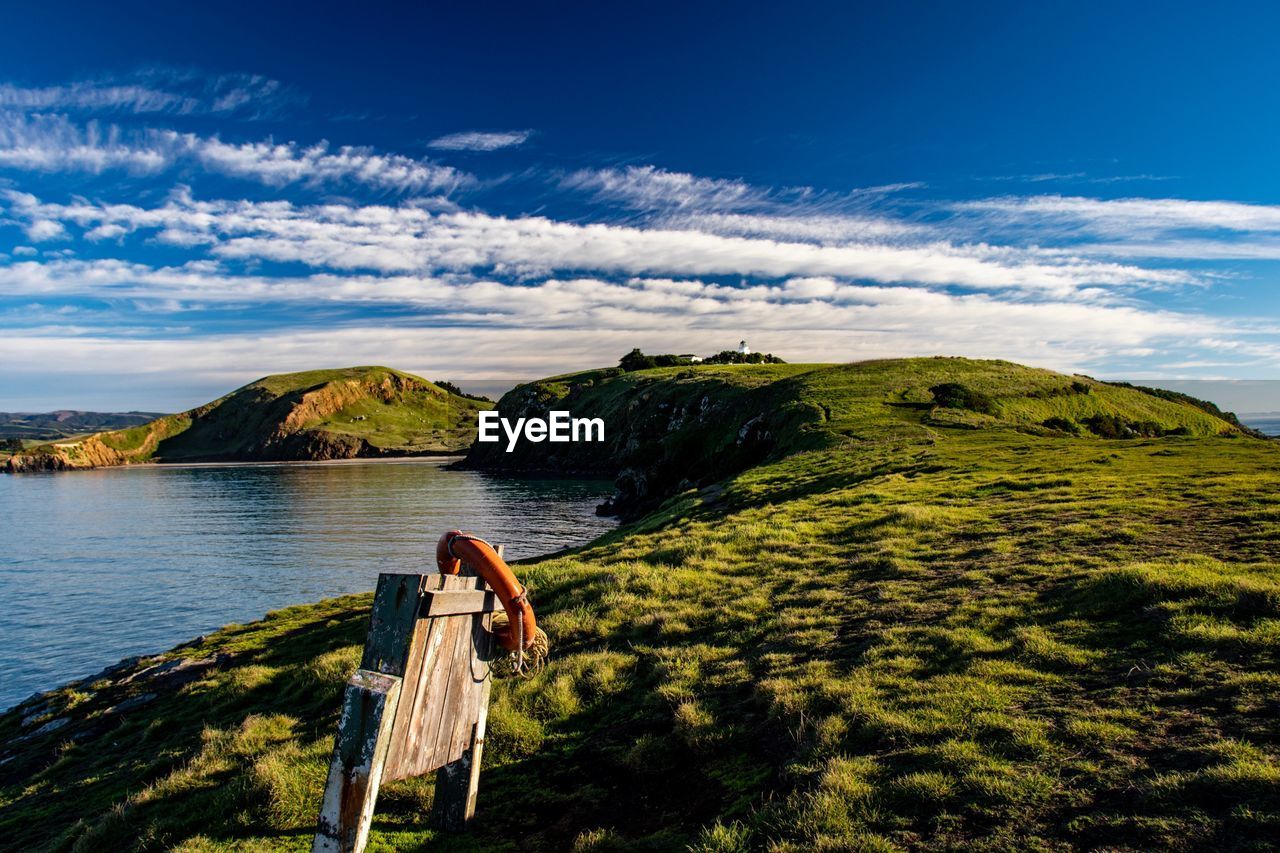 Scenic view of mountain and sea against sky