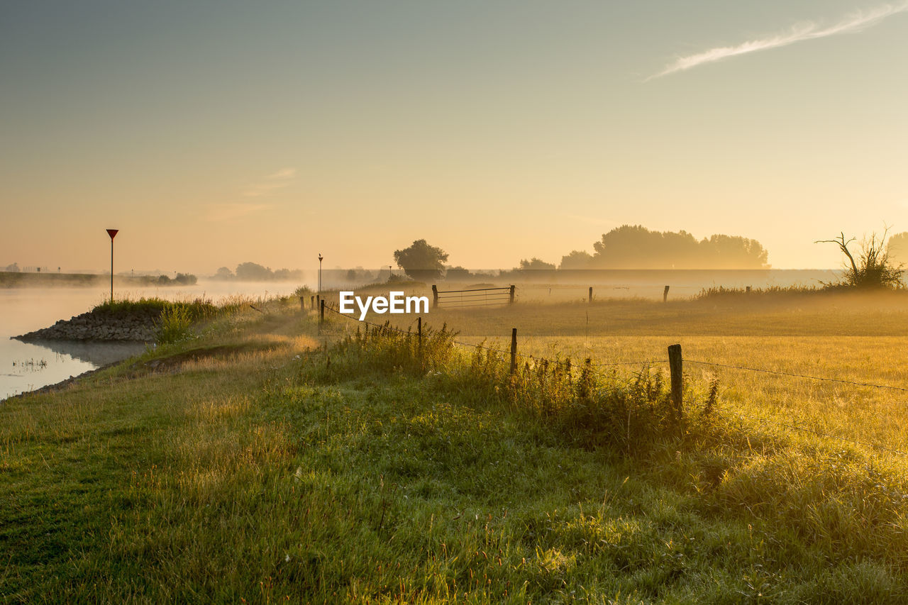 Scenic view of field against sky during sunset