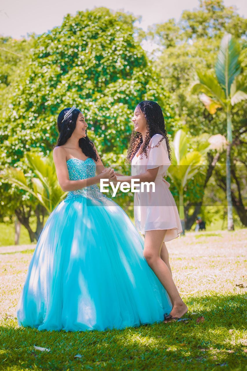 rear view of bride and bridegroom standing on field