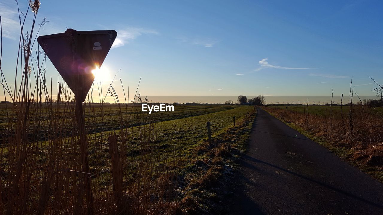 FIELD AGAINST SKY AT SUNSET