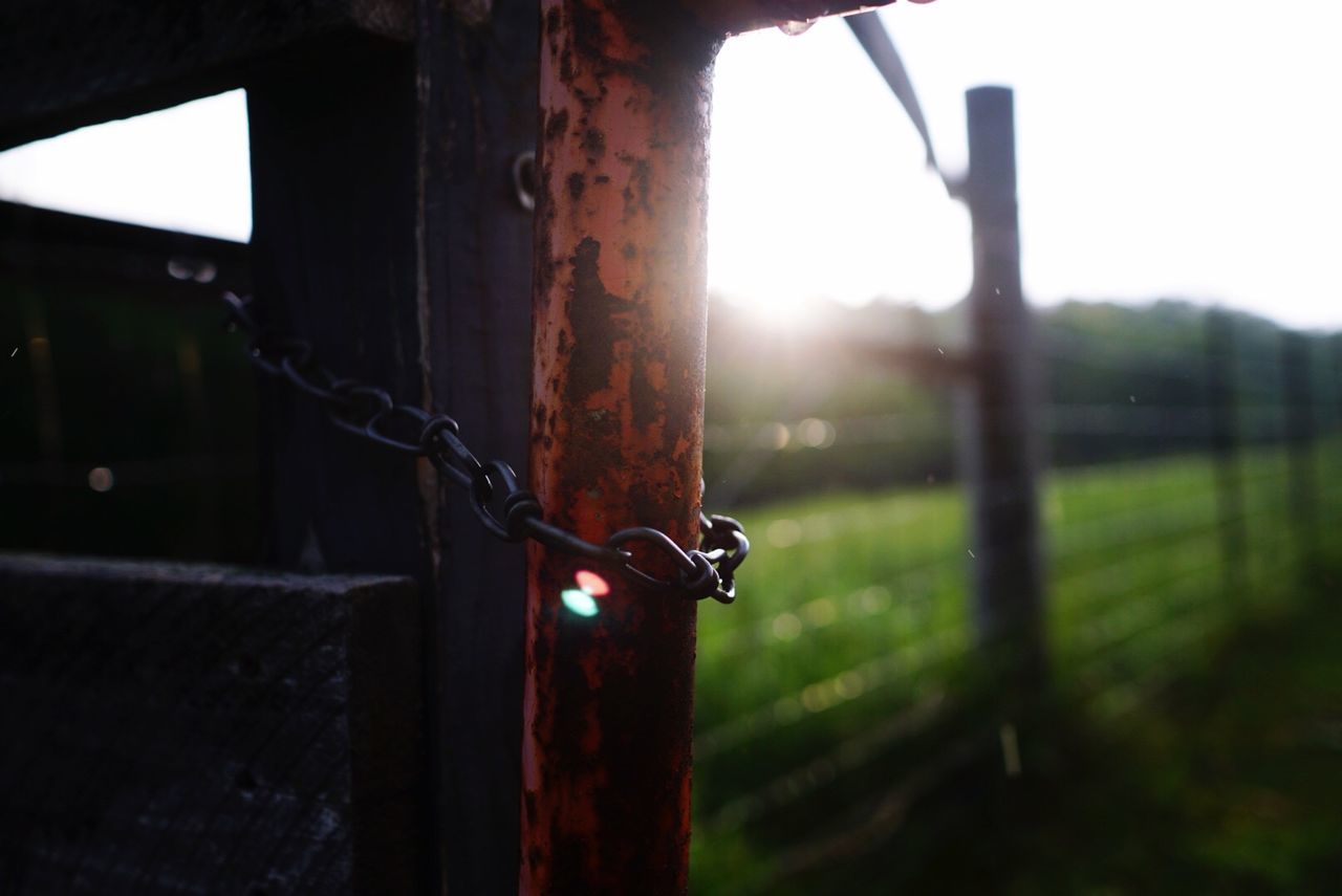 Chain tied to metal post during rainy season