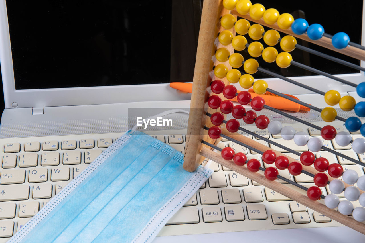 HIGH ANGLE VIEW OF MULTI COLORED PENCILS ON TABLE AT HOME