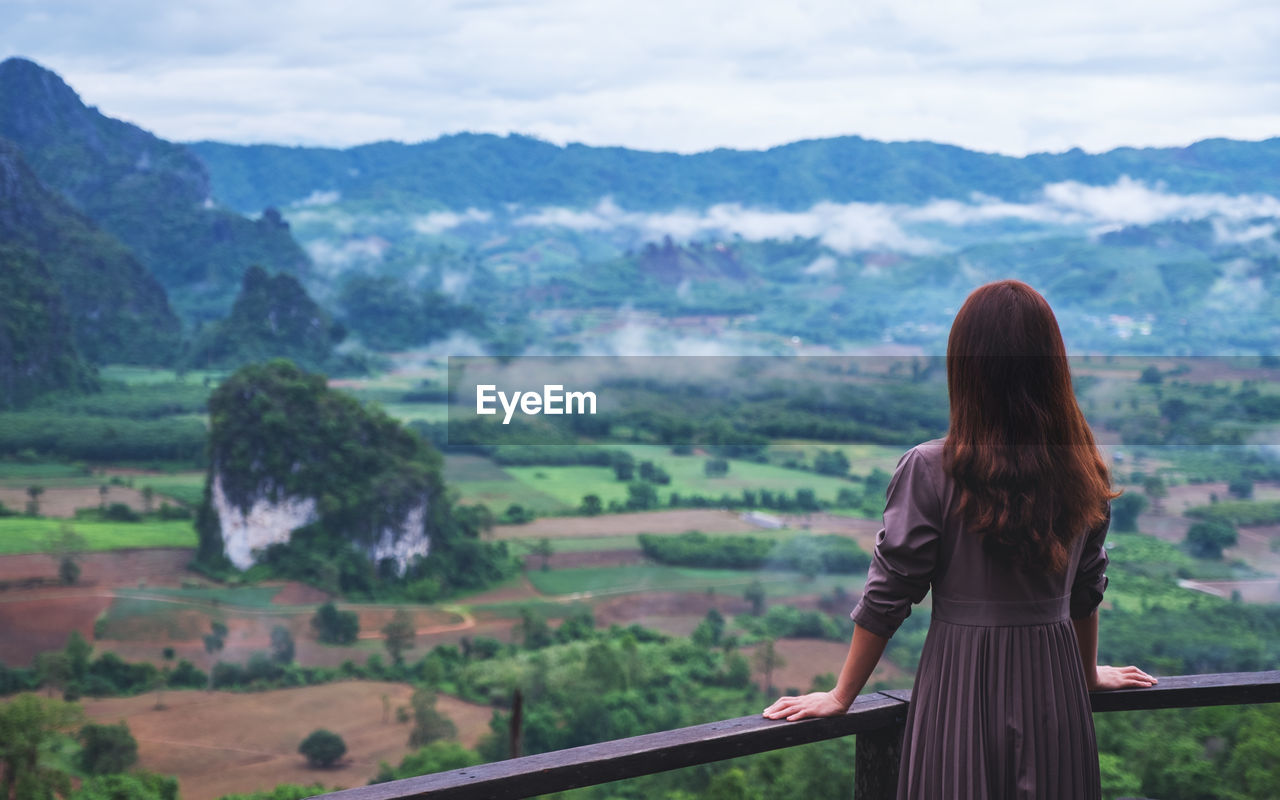 rear view of woman looking at mountains