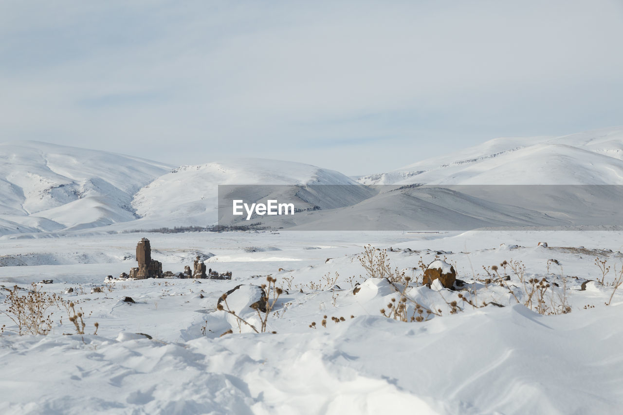 Scenic view of snow covered mountains against sky