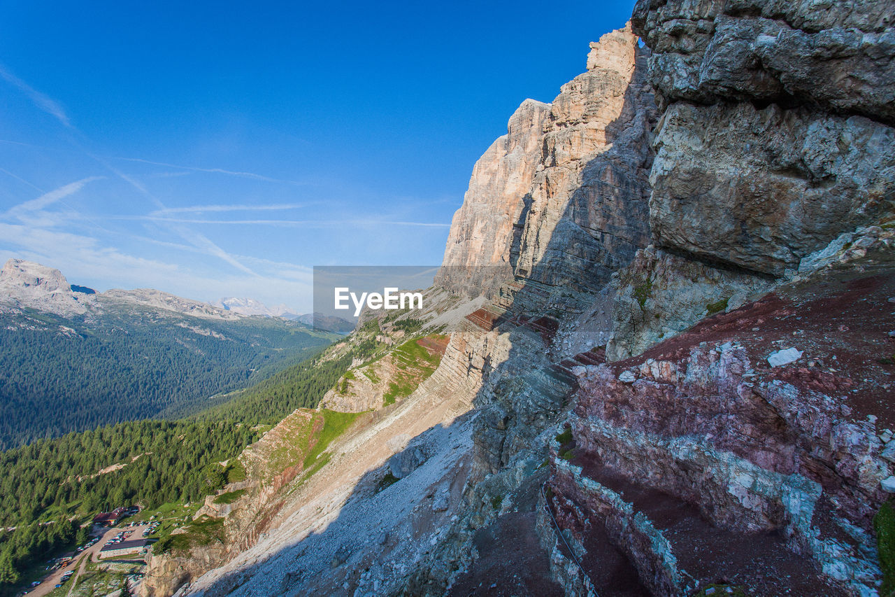 Scenic view of mountains against blue sky