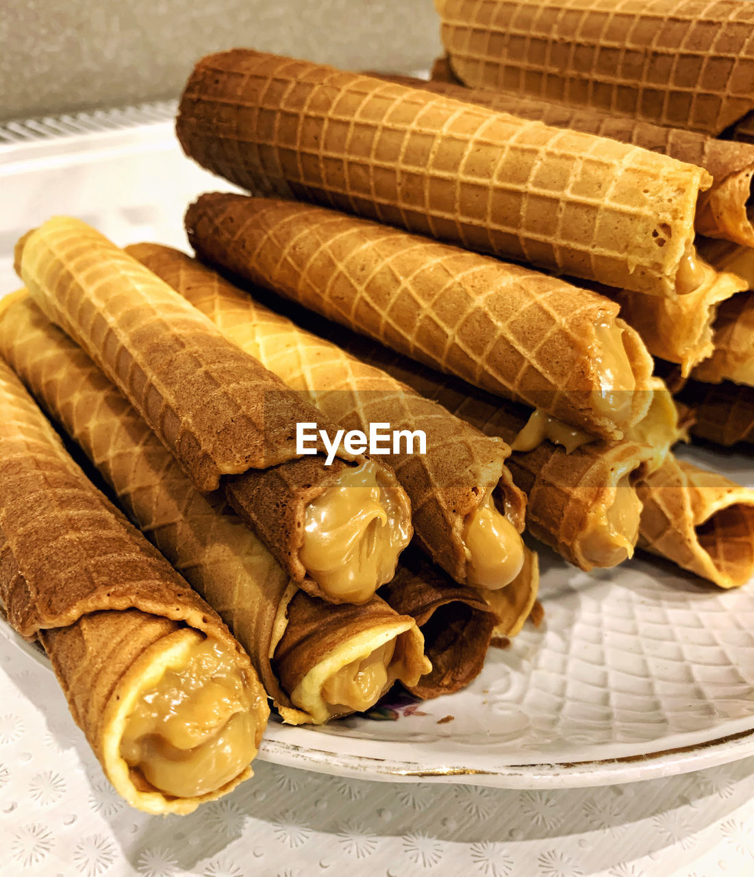 Appetizing wafer rolls with boiled condensed milk. delicious homemade sweets.