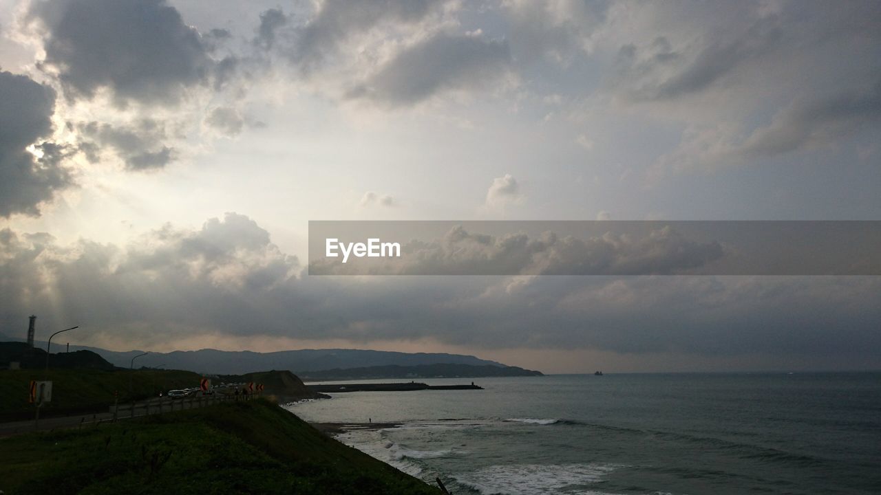 View of beach against cloudy sky