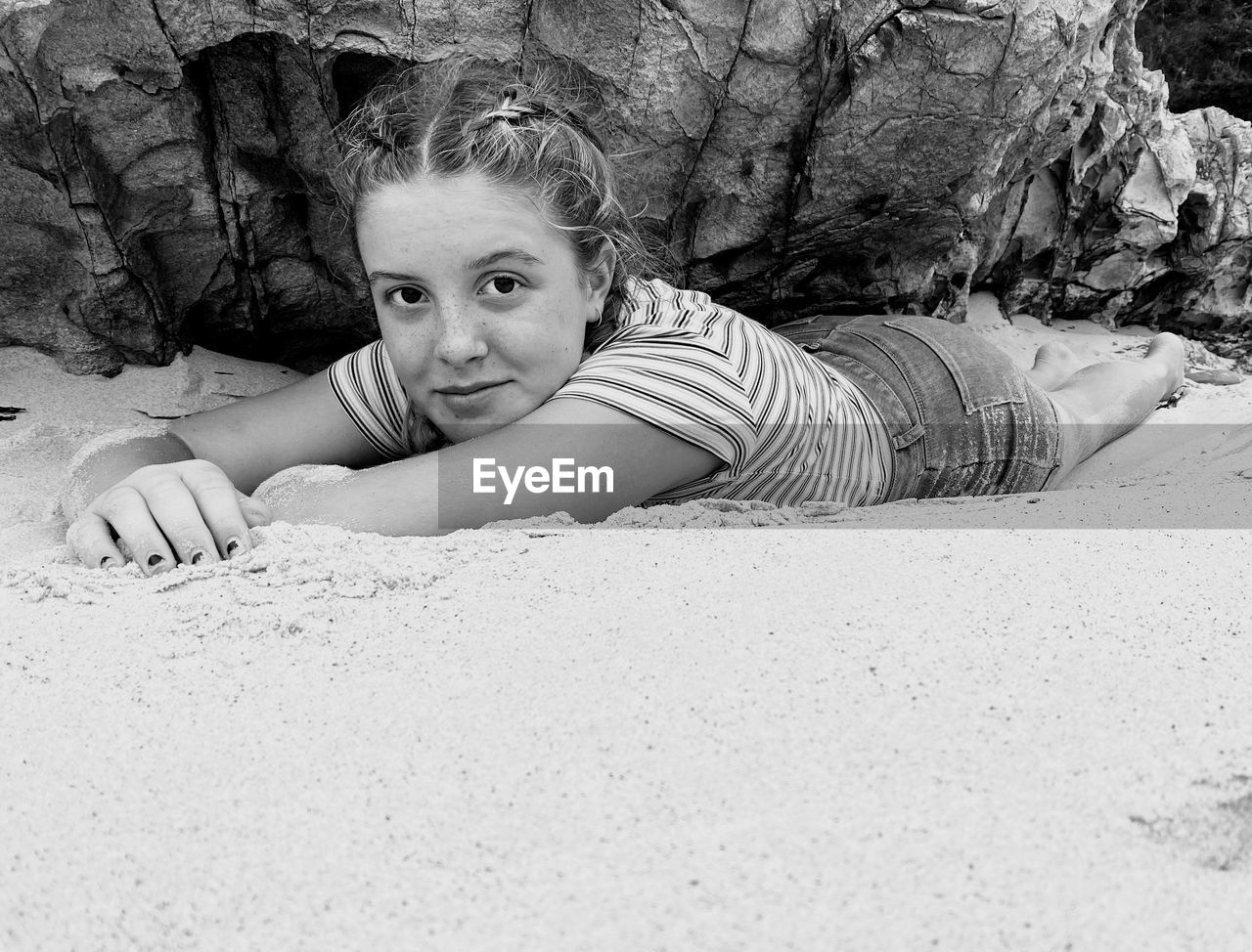 Portrait of girl lying down on beach