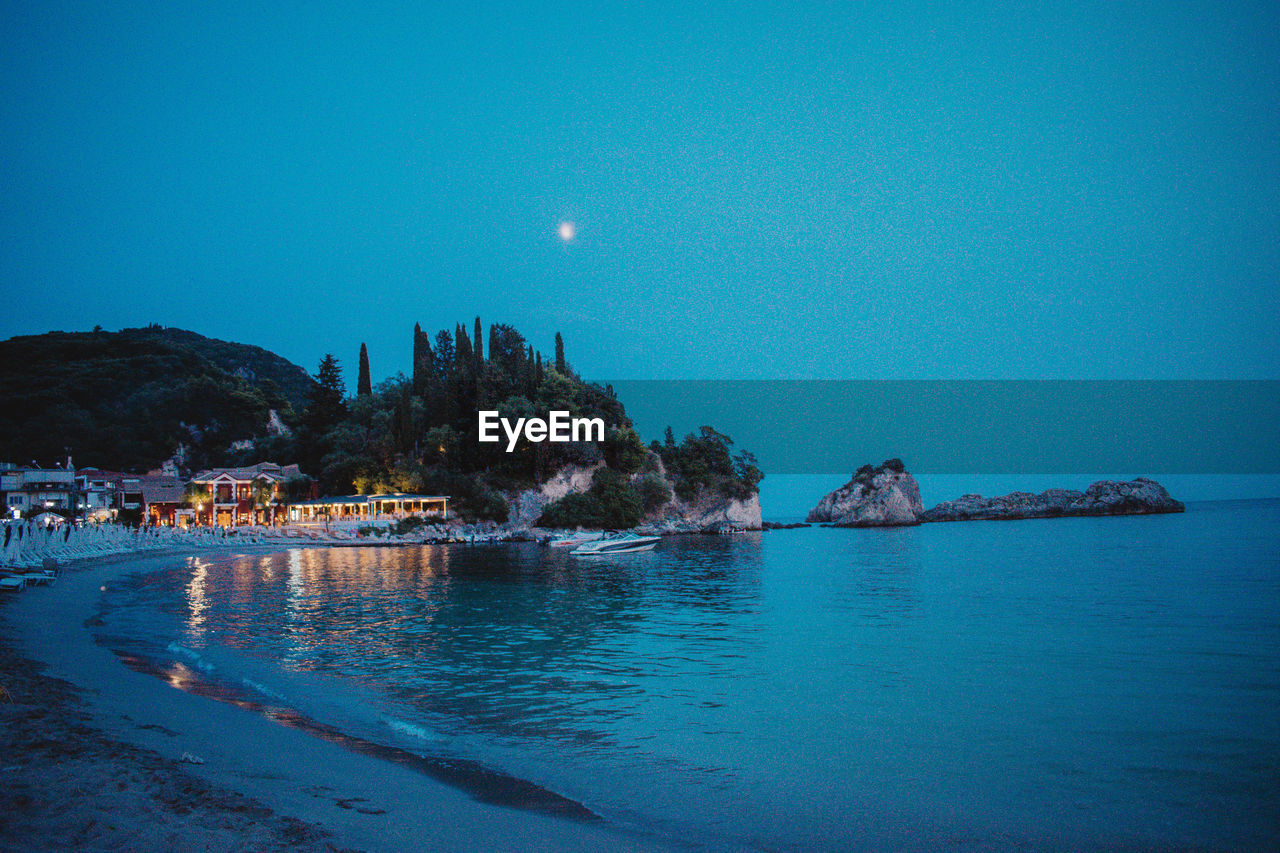 Scenic view of sea against clear blue sky